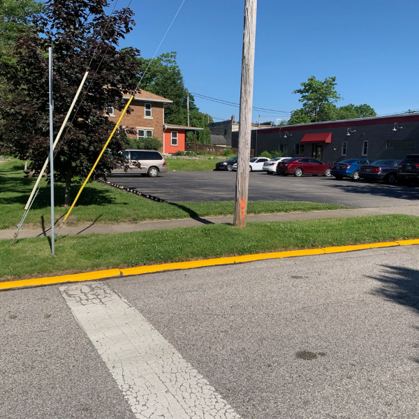 A paved street with a newly painted yellow curb