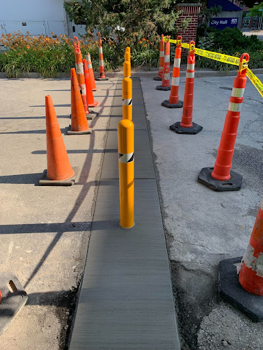 Safety Bollards Being Installed in Showers Parking Lot