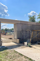 Bicentennial gateway being constructed of limestone blocks, with wires that will provide electric service for the backlighted "Bloomington" letters